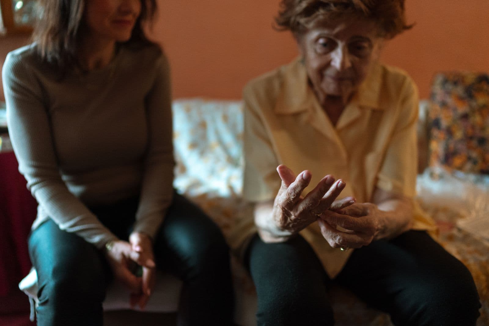 Caregiver spending time with an older woman at home